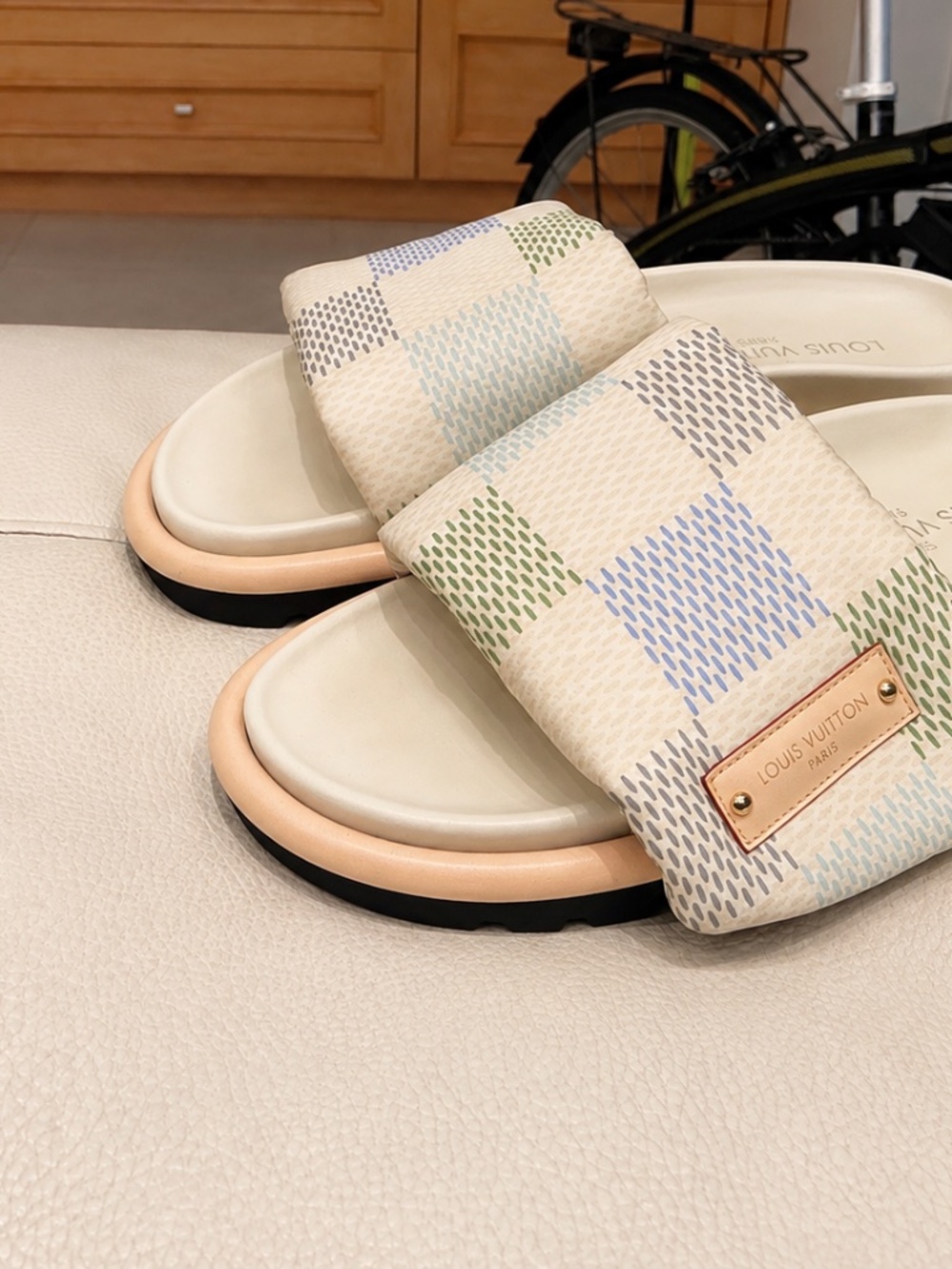 Beautiful Louis Vuitton slides featuring the iconic light canvas-style pattern w